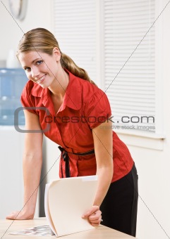 Businesswoman looking at file folder
