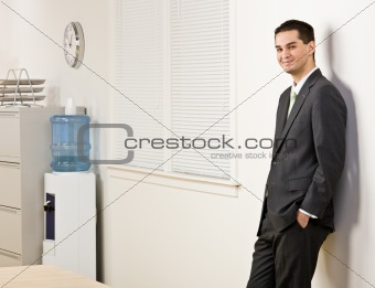 Businessman leaning on wall