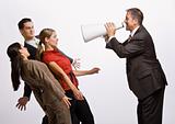 Businessman shouting at co-workers with megaphone