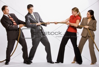 Business people playing tug-of-war