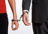 Business people handcuffed together