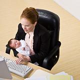 Businesswoman With Baby at Desk