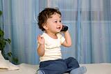 Baby with telephone.