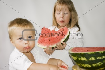 Two children eat Watermelon