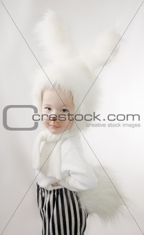 Little girl in a white downy bunny costume.