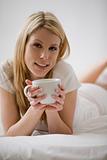 Woman In Bed With Coffee Cup