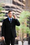 Businessman Standing Outside and Using Cell Phone