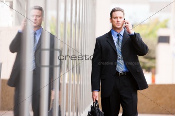 Businessman Outdoors With Cell Phone and Briefcase
