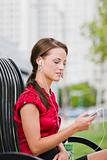 Woman With Headphones Sitting on Bench