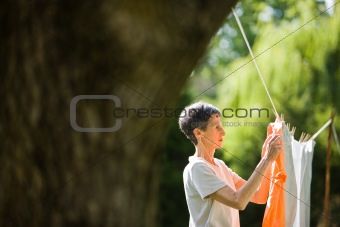 Senior Woman Hanging Clothes to Dry
