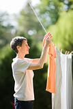 Older Woman Hanging Laundry on Clothesline