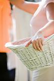 Woman Holding a Laundry Basket