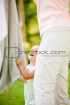 Child pulling on towel on clothes line