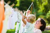 Mother & Child Hanging Clothes on Clothesline