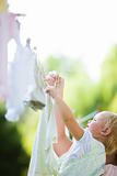 Toddler Helping Mom Hang Laundry on Clothesline