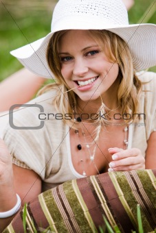 Woman With Hat Reclining in the Grass