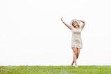 Woman In Meadow With Arms Outstretched
