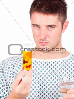 Young patient holding a bottle of pills