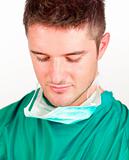 Young male doctor looking down wards