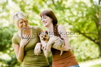 Women with dog walking in a park
