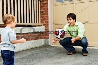 Father and son playing soccer