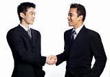 Chinese businessman shaking hands with African associate, closin