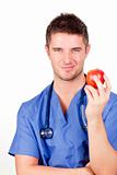 Attractive doctor holding a red apple