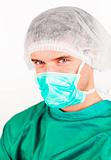 Surgeon with mask and hat on looking at the camera