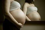 pregnant woman in front of mirror