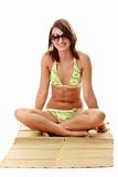 Lady wearing swimsuit on bamboo mat