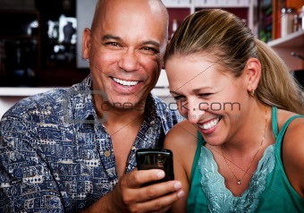 Couple in Coffee House with Cell Phone