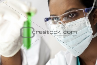 Asian Female Scientist or Doctor With Green Solution In Laborato