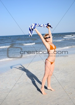 girl standing in the wind on the beach 