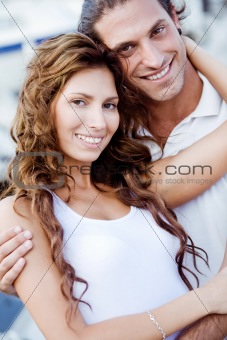 Happy young couple embracing outdoors