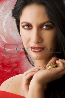 woman red and gold make up