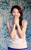 beautiful Asian lady in front of mosaic and laughing