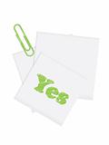 Paper note with a green paperclip and with the word "Yes"