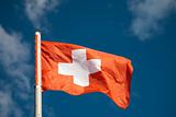 Swiss flag against blue sky