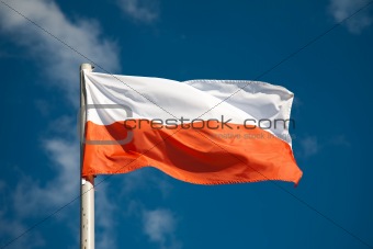 Polish flag against blue sky