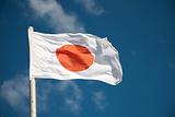 Japanese flag against blue sky