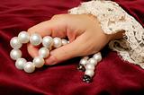 Holding a pearls necklace