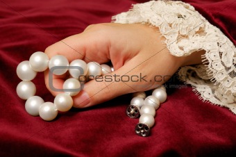 Holding a pearls necklace