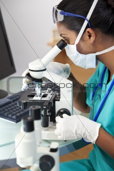 Asian Woman Doctor or Scientist Using a Microscope In Laboratory