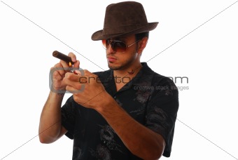 Handsome man lighting a cigar