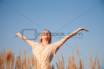 Happy woman under the blue sky
