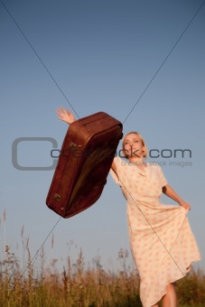 Woman throws a suitcase