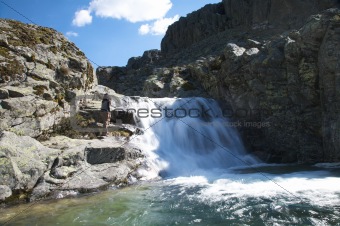 hiking woman next waterfall