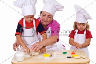 Grandmother teaching kids how to make cookies