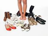 Woman having a hard time choosing what shoes to wear.