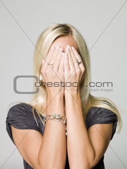 Portrait of a woman hiding in her hands